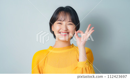 A woman showing an OK sign 112423697