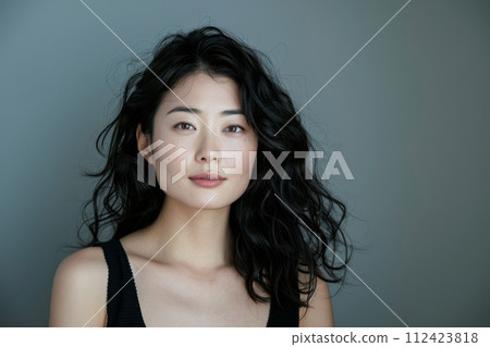 Beauty portrait of a natural young Japanese woman with a soft grey copy space background 112423818