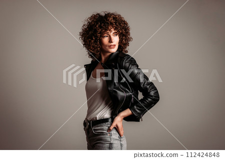 Adult woman with hands in her hair posing sensually from the side 112424848