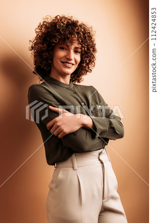 Adult woman smiling and posing in photographic studio 112424853