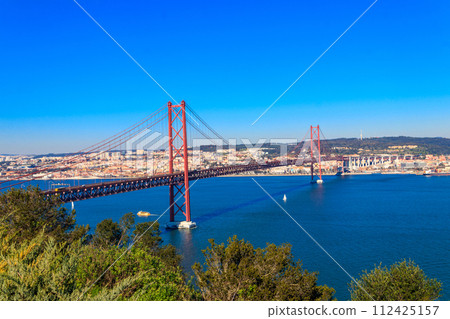 The 25th April Bridge (Ponte 25 de Abril) is a suspension bridge road-rail over the Tagus river that connects the city of Lisbon to the city of Almada. View from Almada. The 25th April Bridge (Ponte 25 de Abril) is a suspension bridge road-rail over the Tagus river that connects the city of Lisbon to the city of Almada. View from Almada. 112425157