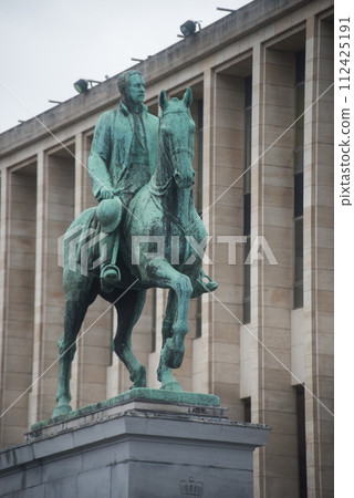 Brussels - Belgium - 3 March 2024 - Brussels - Belgium - 3 March 2024 - front view of bronze statue of the king of horse on building background 112425191