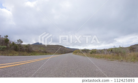 In this serene winter scene, a vehicle carefully makes its way along Los Osos Valley Road and Pecho Valley Road within Montana de Oro State Park. 112425893