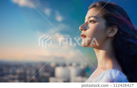 Profile of a woman staring into the distance with strong eyes 112426427