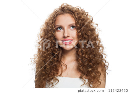 Friendly young healthy lady looking up portrait. Perfect woman with long frizzy hairstyle Friendly young healthy lady looking up portrait. Perfect woman with long frizzy hairstyle 112428430