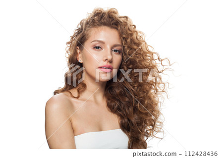 Fashion portrait of healthy model with natural make-up, shiny clear skin and long curly hairstyle. Fashion portrait of healthy model with natural make-up, shiny clear skin and long curly hairstyle. 112428436
