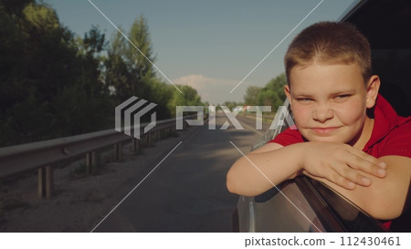 car, child, kid, boy, teenager, trip, road, travel, vacation, young boy leans out car window, resting his arms smiling coyly, enjoys warm day. road stretches into distance, flanked by greenery under car, child, kid, boy, teenager, trip, road, travel, vacation, young boy leans out car window, resting his arms smiling coyly, enjoys warm day. road stretches into distance, flanked by greenery under 112430461