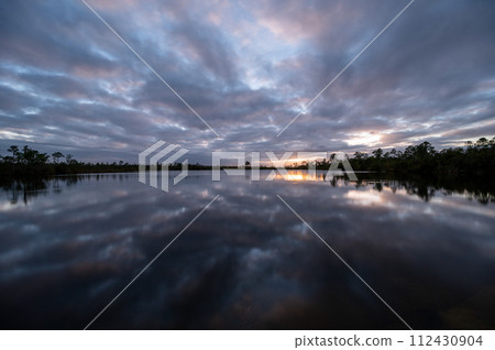 Sunset cloudscape over Pine Glades Lake in Everglades National Park, Florida. Sunset cloudscape over Pine Glades Lake in Everglades National Park, Florida. 112430904