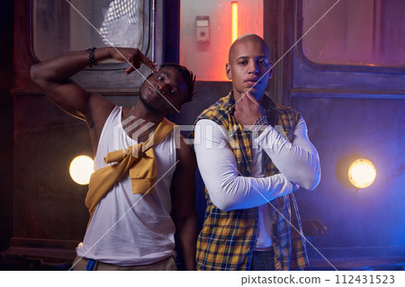 Group of cool emotional guys performing hip-hop style in underground Group of cool emotional guys performing hip-hop style in underground 112431523