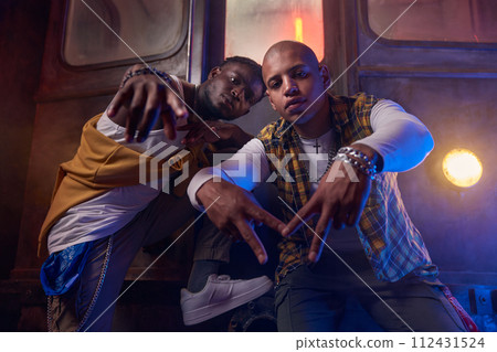 Two emotional guys performing hip-hop style in underground Two emotional guys performing hip-hop style in underground 112431524