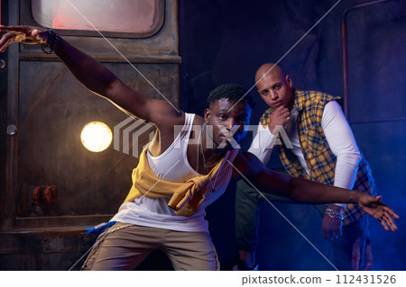 Two modern hip-hop dancers in garage performing urban freestyle dance 112431526