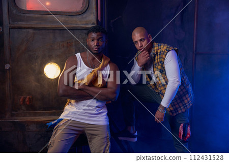 Two modern hip-hop dancers in garage performing urban freestyle dance Two modern hip-hop dancers in garage performing urban freestyle dance 112431528