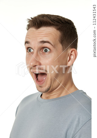 surprised guy looking at camera on white studio background 112431543