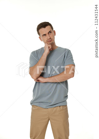 Young confused puzzled man isolated on white background 112431544