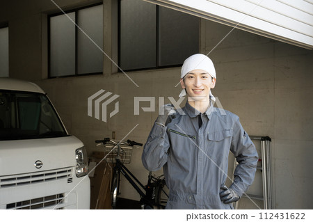 A man working in the waste collection business makes a fist pump 112431622