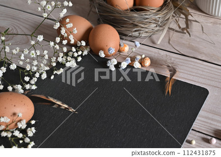 Create an Easter composition of Easter quail eggs and flowers on a white wooden background. A greeting card for the Easter holiday.Top view, copy location, flat layout. Create an Easter composition of Easter quail eggs and flowers on a white wooden background. A greeting card for the Easter holiday.Top view, copy location, flat layout. 112431875