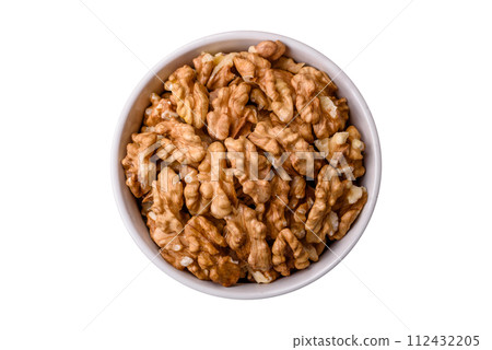 Delicious fresh peeled raw walnuts in a ceramic plate 112432205