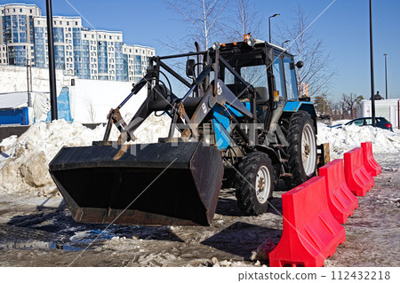 A tractor with a bucket and a brush. A tractor with a bucket and a brush. 112432218