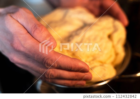 Professional chef kneading dough in restaurant kitchen, closeup shot 112432842
