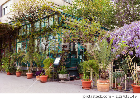 Beautiful fasade of vintage cafe decorated flower pots and plants. City and travel Beautiful fasade of vintage cafe decorated flower pots and plants. City and travel 112433149