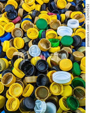 Lots of different plastic bottle caps. Garbage sorting 112433252