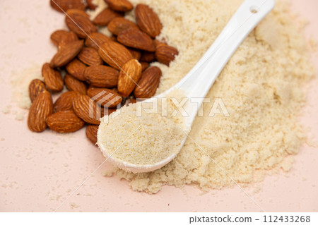 Almond flour and almonds on a beige background Almond flour and almonds on a beige background 112433268