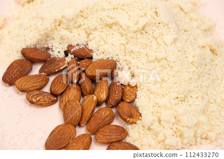 Almond flour and almonds on a beige background 112433270