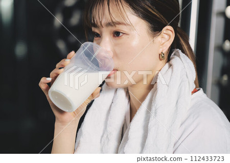 女人在健身房訓練時喝蛋白質 112433723
