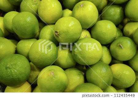 Stack of Limes on a market stall 112435449