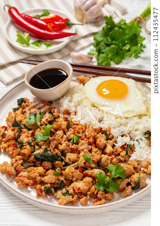 basil chicken stir fry with rice and fried egg basil chicken stir fry with rice and fried egg 112435477