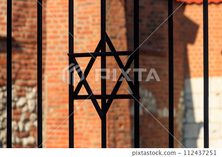 Jewish star of David on the metal fence Jewish star of David on the metal fence 112437251