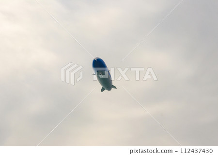Blimp, airship or dirigible flying in sky Blimp, airship or dirigible flying in sky 112437430