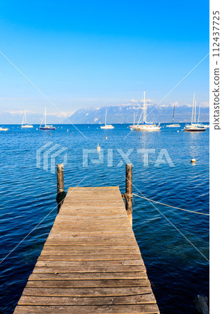 Wooden pier overlooking the Alps and Lake Geneva in Switzerland Wooden pier overlooking the Alps and Lake Geneva in Switzerland 112437725