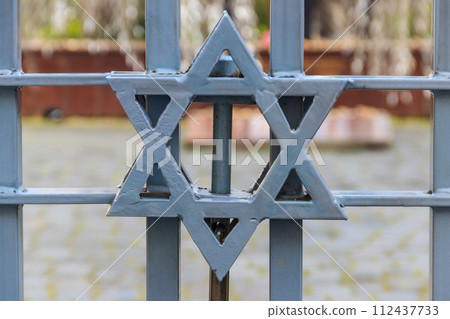 Jewish star of David on the metal fence 112437733