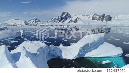 Close up melting iceberg on waters of Southern Ocean to ice-shelves, glaciers and mountains aerial. Distinct natural environments of Antarctica. Changing climate and global warming problem, rising sea 112437951