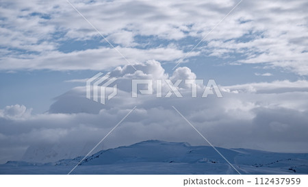 White clouds over mountain range aerial. Antarctica desert landscape of polar natural beauty. Epic nature scenery of arctic winter at cloudy day. Environment preserve scene of global warming 112437959