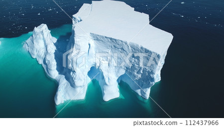 Antarctica giant iceberg melting in blue water aerial top view. Nature beauty of towering glacier cavity arctic ice. South Pole winter scene. Ecology climate change, global warming concept. Drone shot Antarctica giant iceberg melting in blue water aerial top view. Nature beauty of towering glacier cavity arctic ice. South Pole winter scene. Ecology climate change, global warming concept. Drone shot 112437966