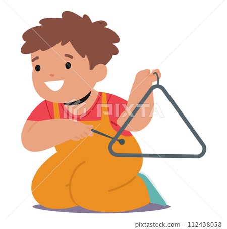 Delightful Little Child Is Engrossed In Play, Sitting On The Floor With Triangle, Exploring The Sounds With Curiosity 112438058
