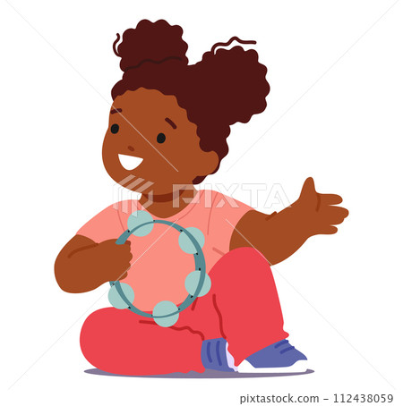 Joyful Little Child, Radiating Happiness, Sits On The Floor, Engrossed In Play, Rhythmically Tapping A Tambourine 112438059
