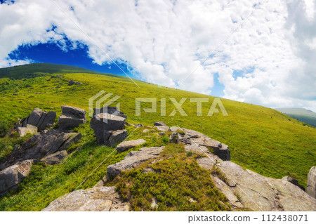 mountainous carpathian landscape in summer. boulders and rock formations among grassy hills. sunny forenoon with clouds on the sky mountainous carpathian landscape in summer. boulders and rock formations among grassy hills. sunny forenoon with clouds on the sky 112438071