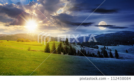 summer landscape with meadow and spruce forest on hills in mountainous area with sun and moon on the sky. day and night time change concept at spring equinox. mysterious countryside scenery in morning summer landscape with meadow and spruce forest on hills in mountainous area with sun and moon on the sky. day and night time change concept at spring equinox. mysterious countryside scenery in morning 112438084