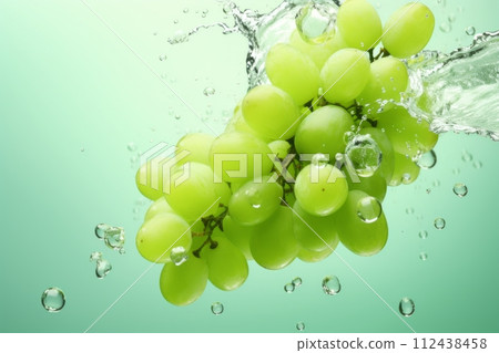 Green grapes in a splash of water and grape juice on a white background Green grapes in a splash of water and grape juice on a white background 112438458