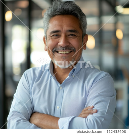 Portrait of a Hispanic male businessman 40 years in a suit against the background of an office 112438608