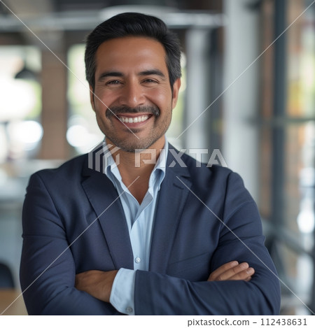 Portrait of a Hispanic male businessman 40 years in a suit against the background of an office 112438631