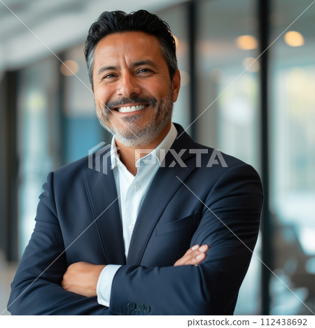 Portrait of a Hispanic male businessman 40 years in a suit against the background of an office 112438692