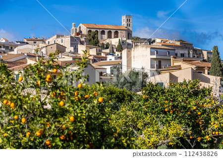 Villagescape of Selva with gothic catholic parish church Esglesia de Sant Llorenc and orange trees, Majorca, Mallorca, Balearic Islands, Spain, Europe 112438826