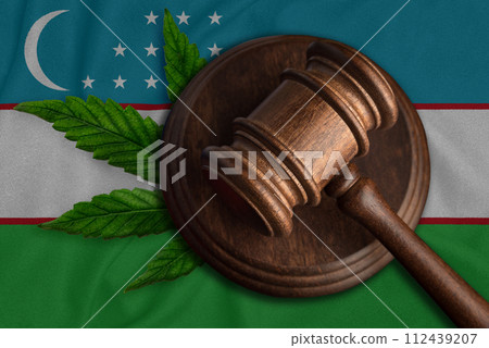 Judges gavel and hemp leaf on the Uzbek flag background. Cannabis legalization in Uzbekistan Judges gavel and hemp leaf on the Uzbek flag background. Cannabis legalization in Uzbekistan 112439207
