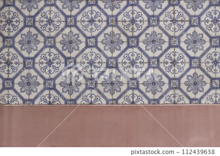 Blue traditional Portuguese ceramic tiles pattern, azulejos. Beautiful shabby dirty pink facade, wall banner. Old Lisbon building decoration Portugal decorative background with geometric stars Blue traditional Portuguese ceramic tiles pattern, azulejos. Beautiful shabby dirty pink facade, wall banner. Old Lisbon building decoration Portugal decorative background with geometric stars 112439638