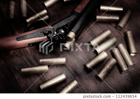 double barreled hunting shotgun with brass cartridges 112439654