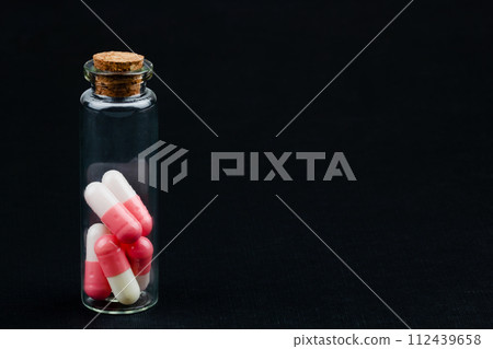 glass jar with colorful pills glass jar with colorful pills 112439658